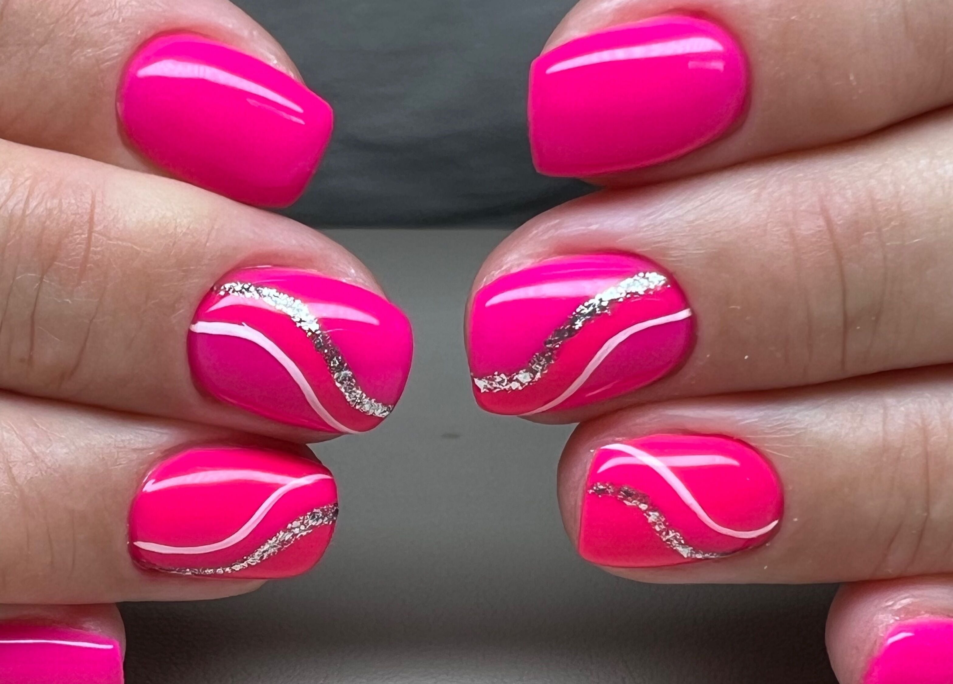 Vibrant pink nails with silver glitter design at Bon-Di Nails, Bristol, Anglia, GB.