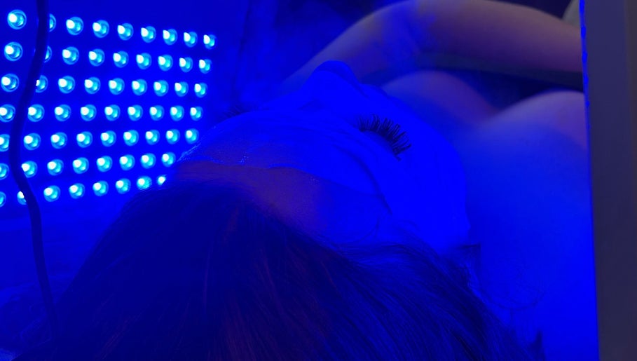 Facial therapy under blue light at Beauty and the Belle in Ash Vale, England, GB, enhancing skin wellness.