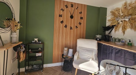 Chic and cozy interior of Glam On The Lash, Trimley Saint Mary, England with green accents and modern decor.