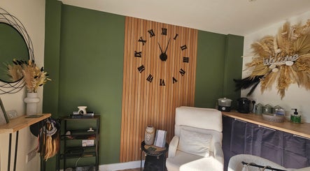 Inviting corner of Glam On The Lash, Trimley Saint Mary, featuring a plush chair and decorative accents.