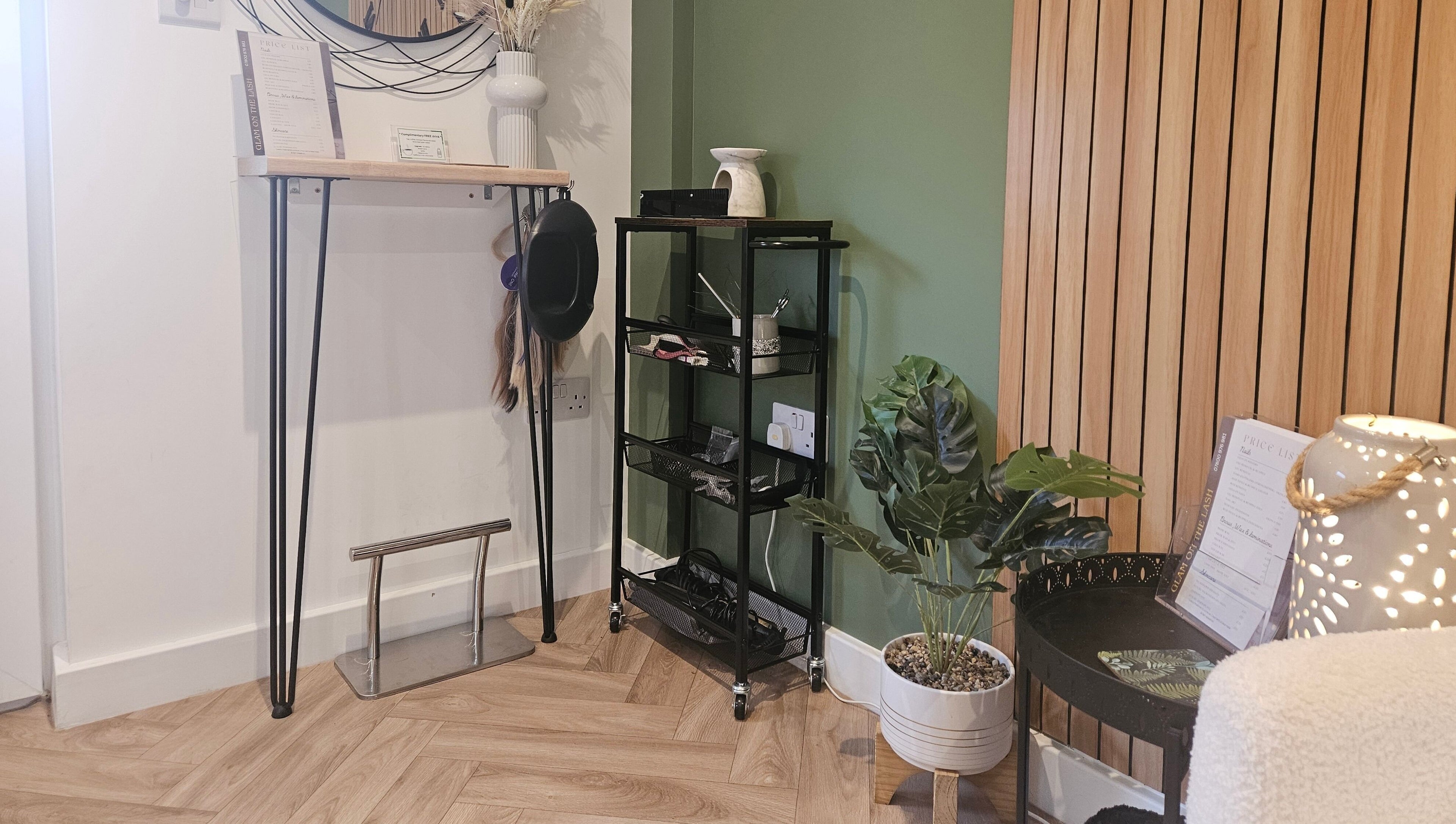 Stylish interior of Glam On The Lash, Trimley Saint Mary, England, GB with decorative plants and wood accents.