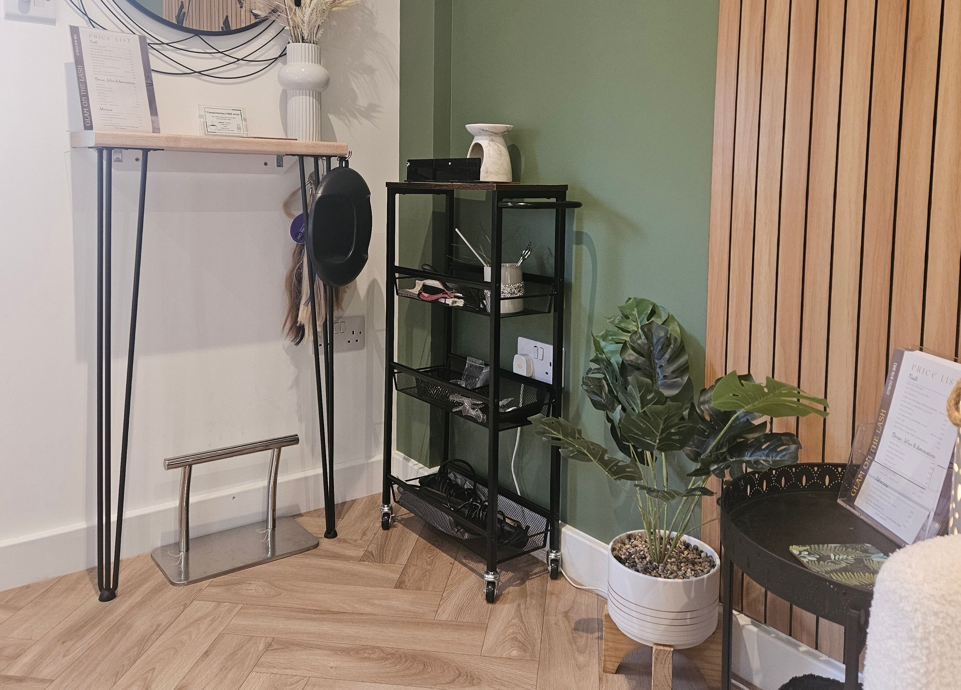 Stylish interior of Glam On The Lash, Trimley Saint Mary, England, GB with decorative plants and wood accents.