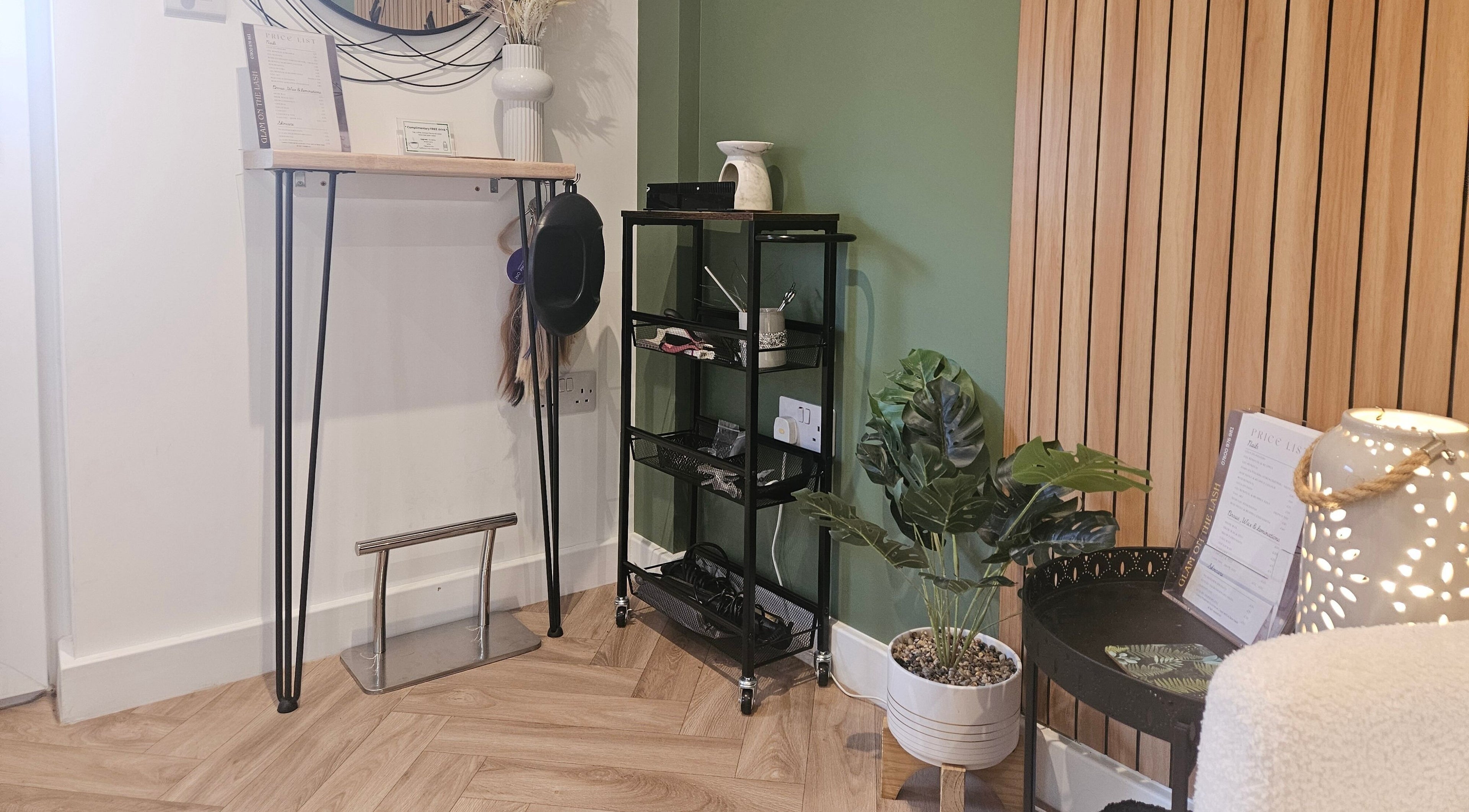 Stylish interior of Glam On The Lash, Trimley Saint Mary, England, GB with decorative plants and wood accents.