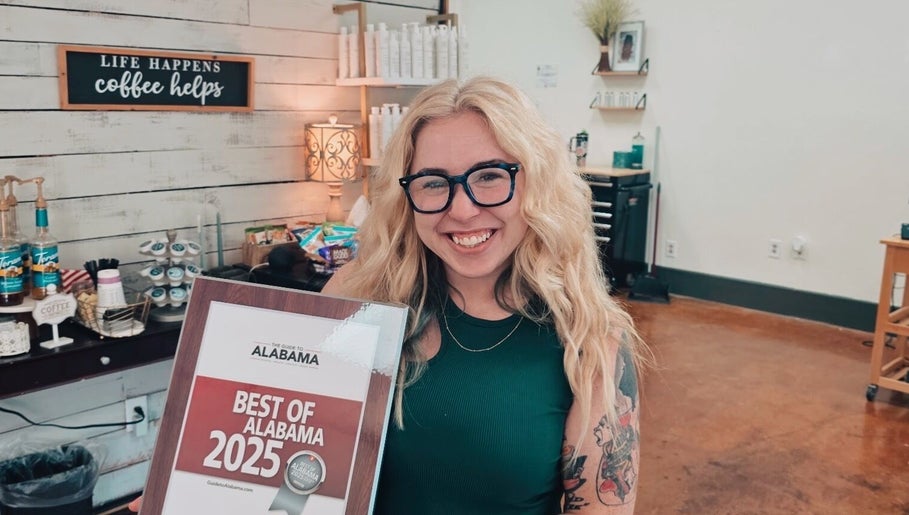 Smiling stylist with award at Luna Jade Salon Independant Stylists in Athens, Alabama, US.