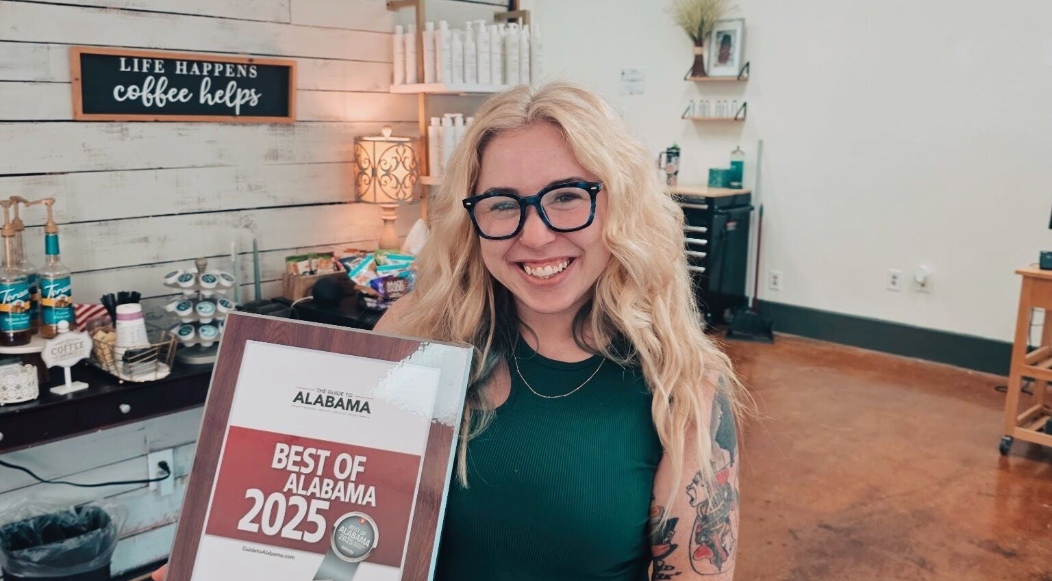Smiling stylist with award at Luna Jade Salon Independant Stylists in Athens, Alabama, US.