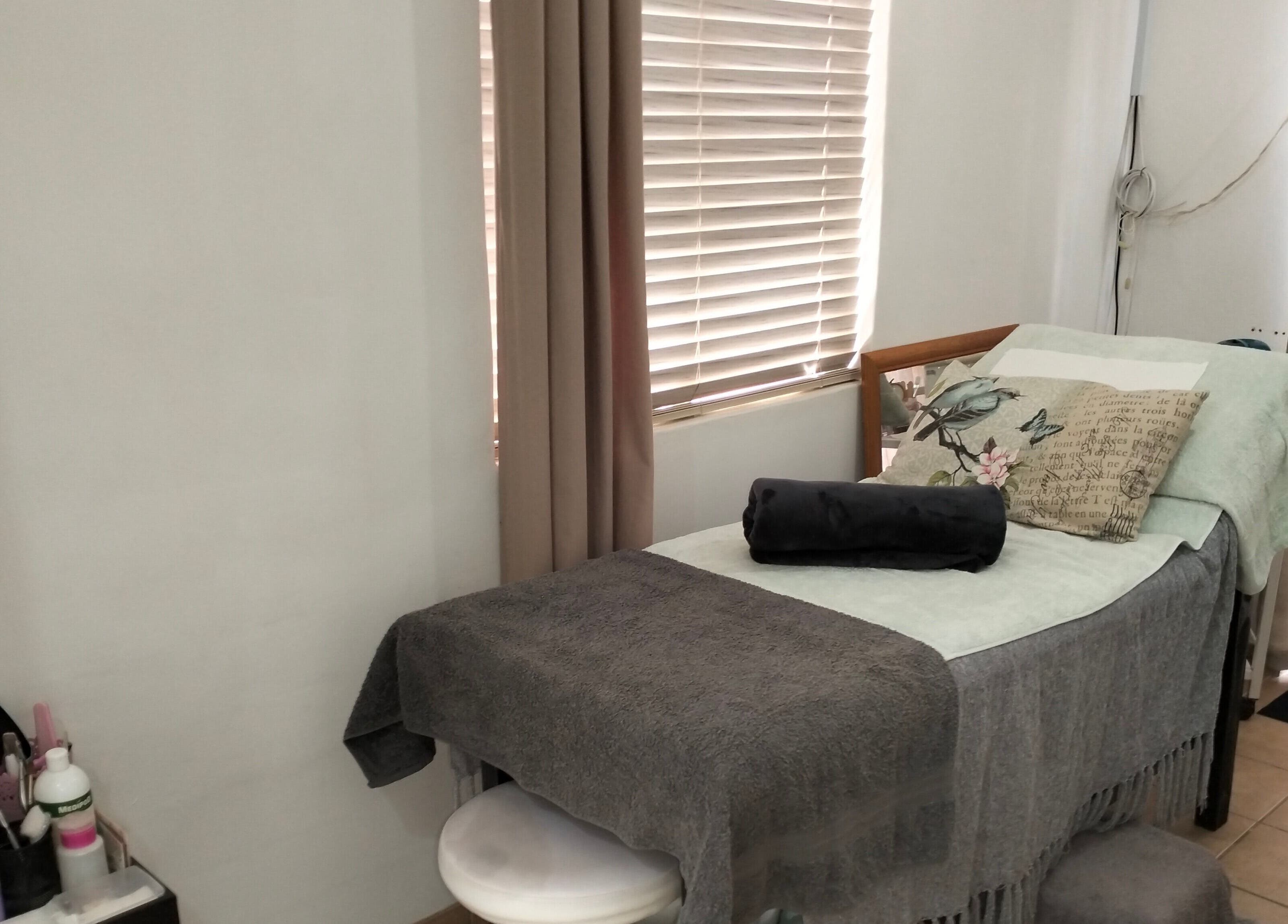 Relaxing treatment room at La Bella Beauty in Cape Town, Western Cape, ZA, with cozy bed and decor.