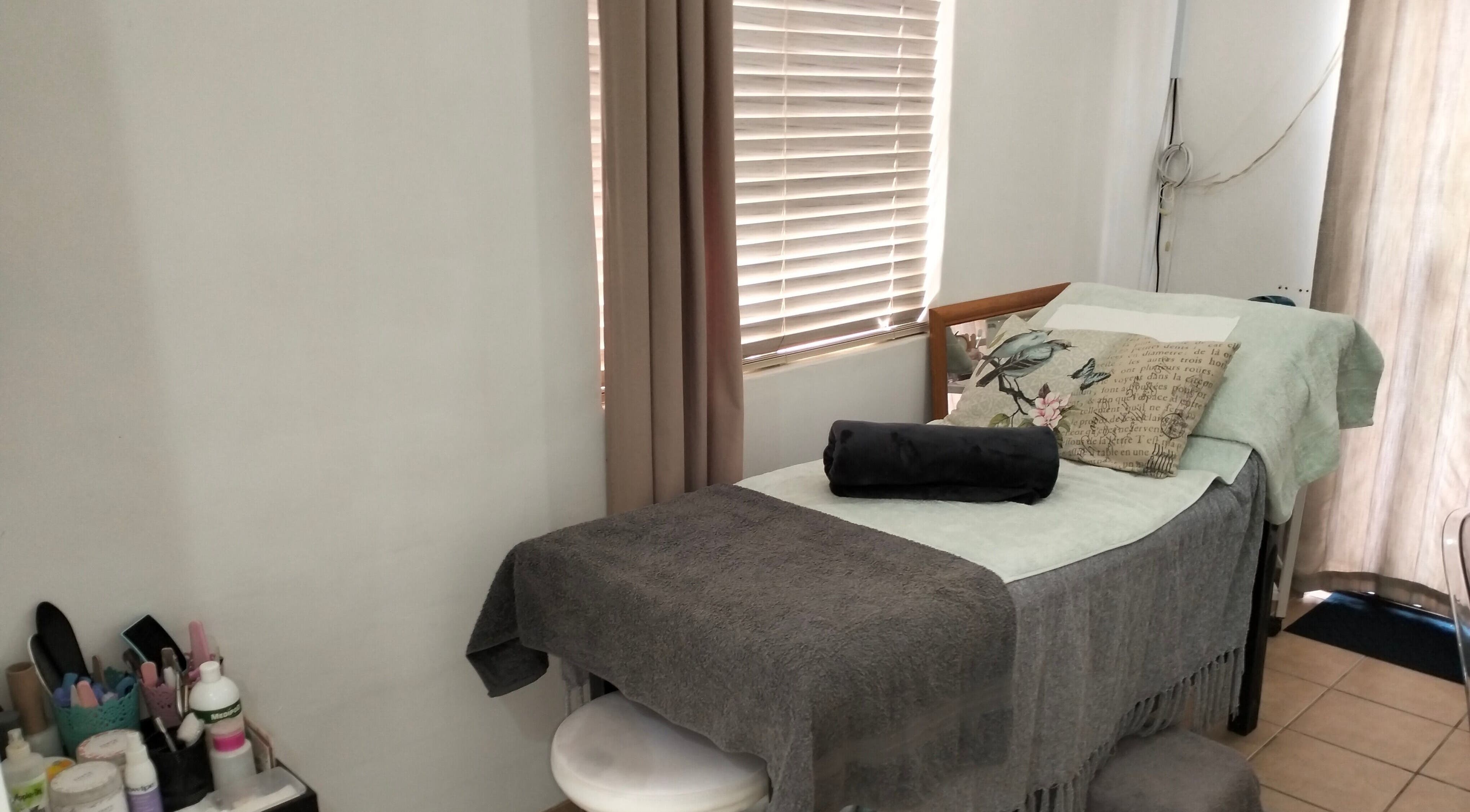 Relaxing treatment room at La Bella Beauty in Cape Town, Western Cape, ZA, with cozy bed and decor.