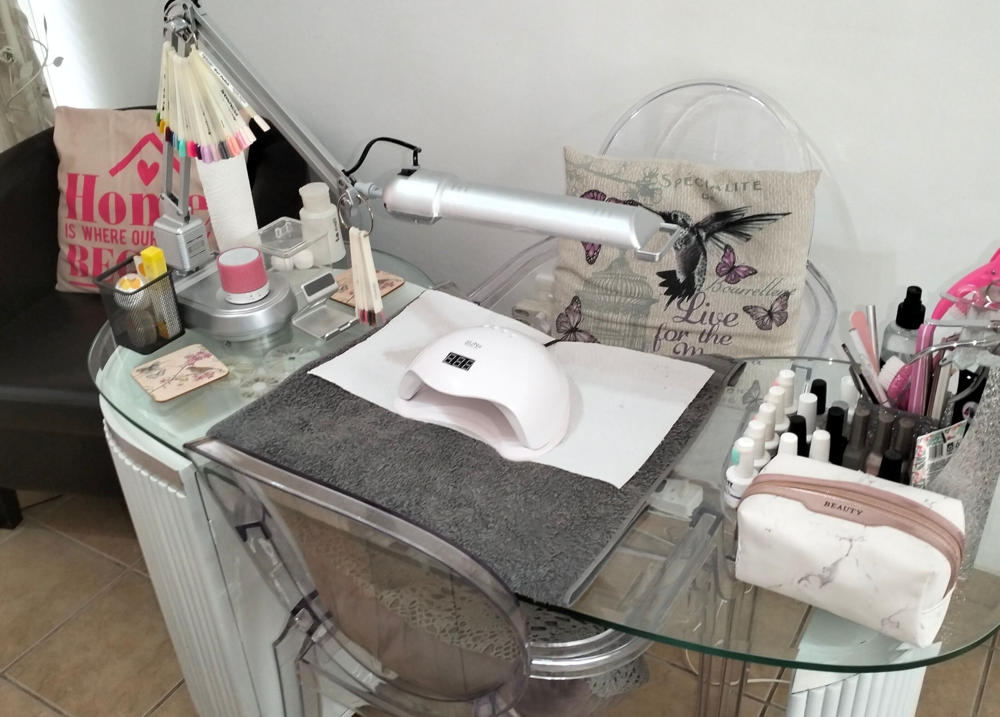 Nail care station at La Bella Beauty in Cape Town, Western Cape, ZA, featuring tools and a UV lamp.
