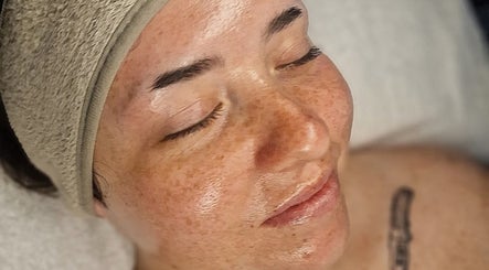 Relaxed woman receiving facial treatment at Amethyst Aesthetics Exmouth, Exmouth, England, GB.