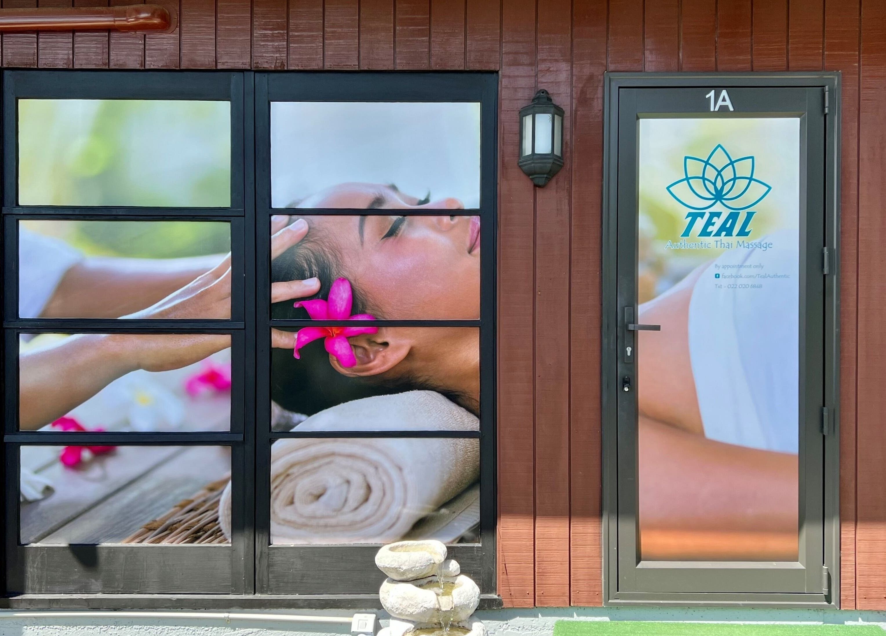 Entrance of Teal Authentic Thai Massage in Gisborne, NZ, showcasing serene spa imagery and signage.