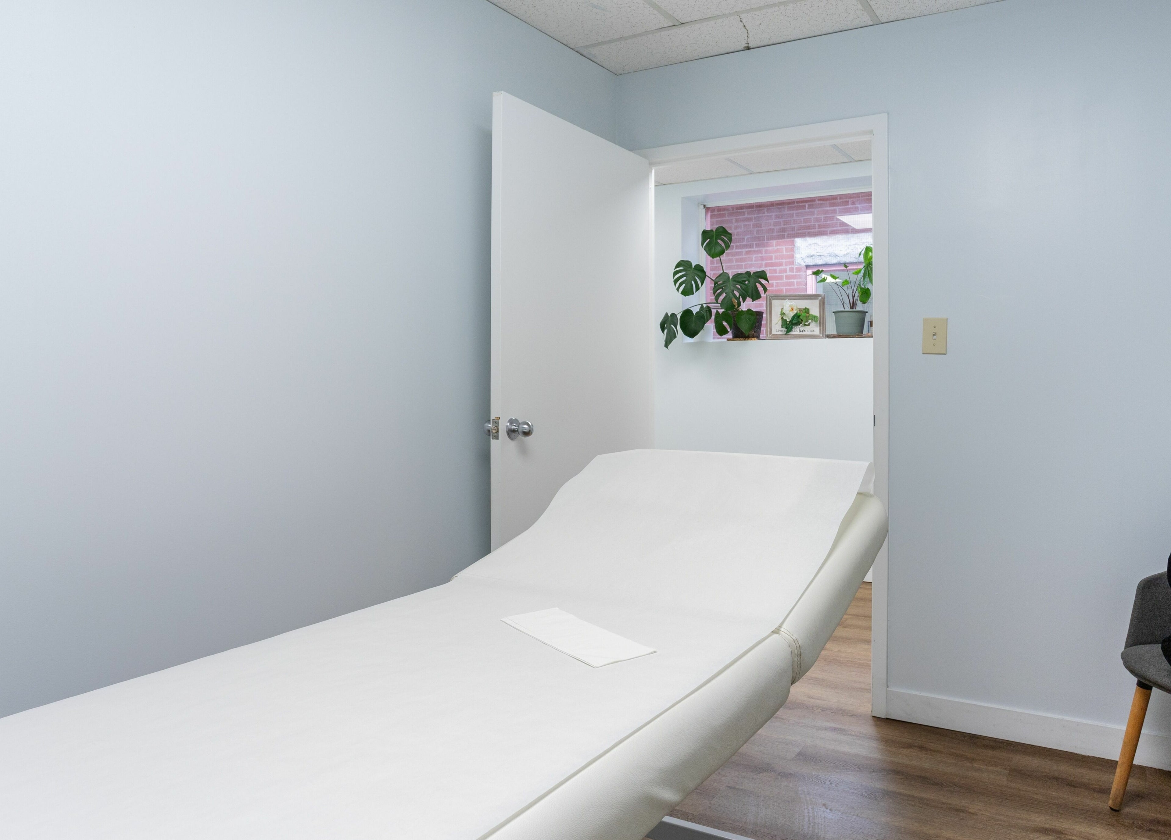 Relaxing treatment room at Lovely Sugaring in Toronto, Ontario, CA with a comfortable massage bed.