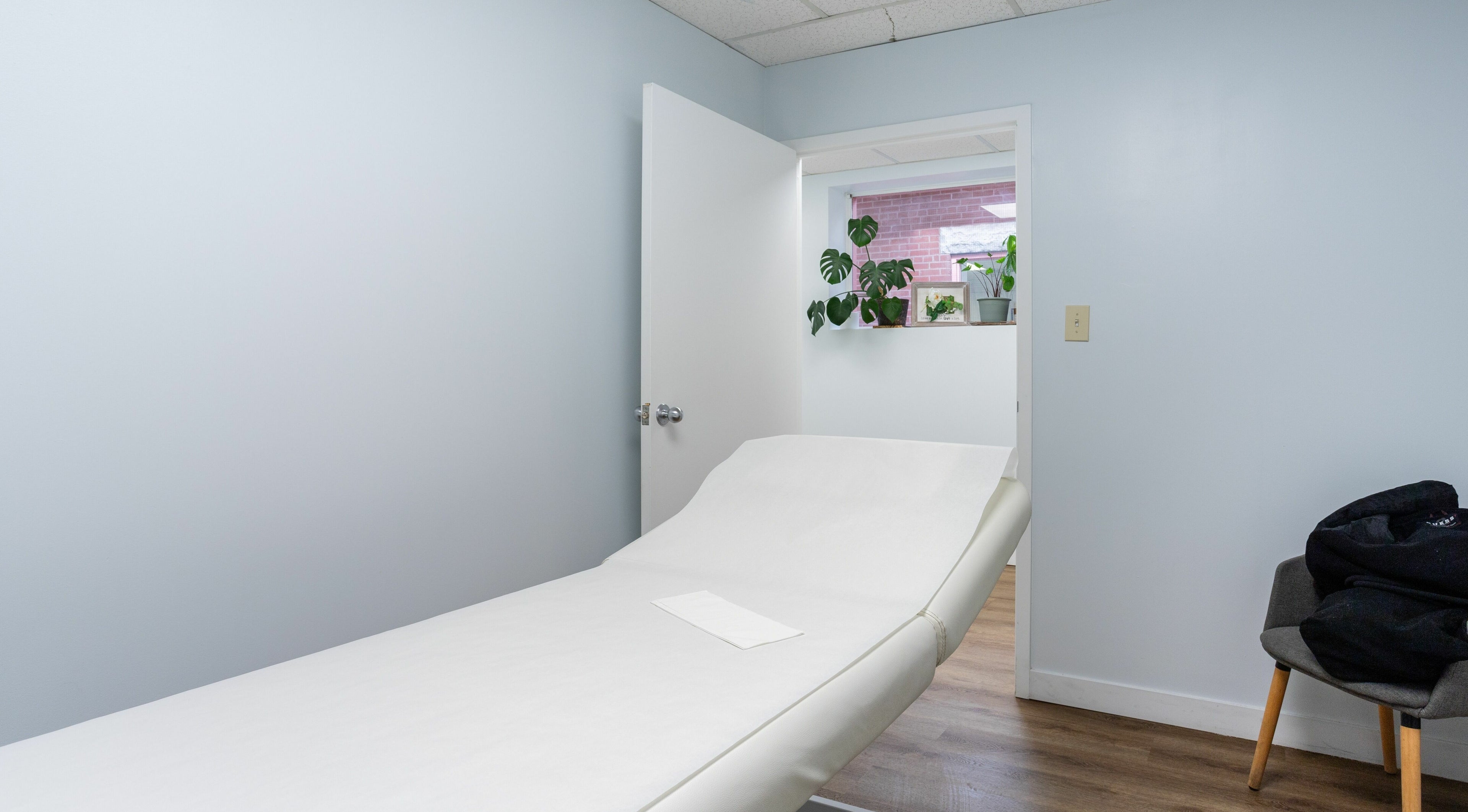 Relaxing treatment room at Lovely Sugaring in Toronto, Ontario, CA with a comfortable massage bed.