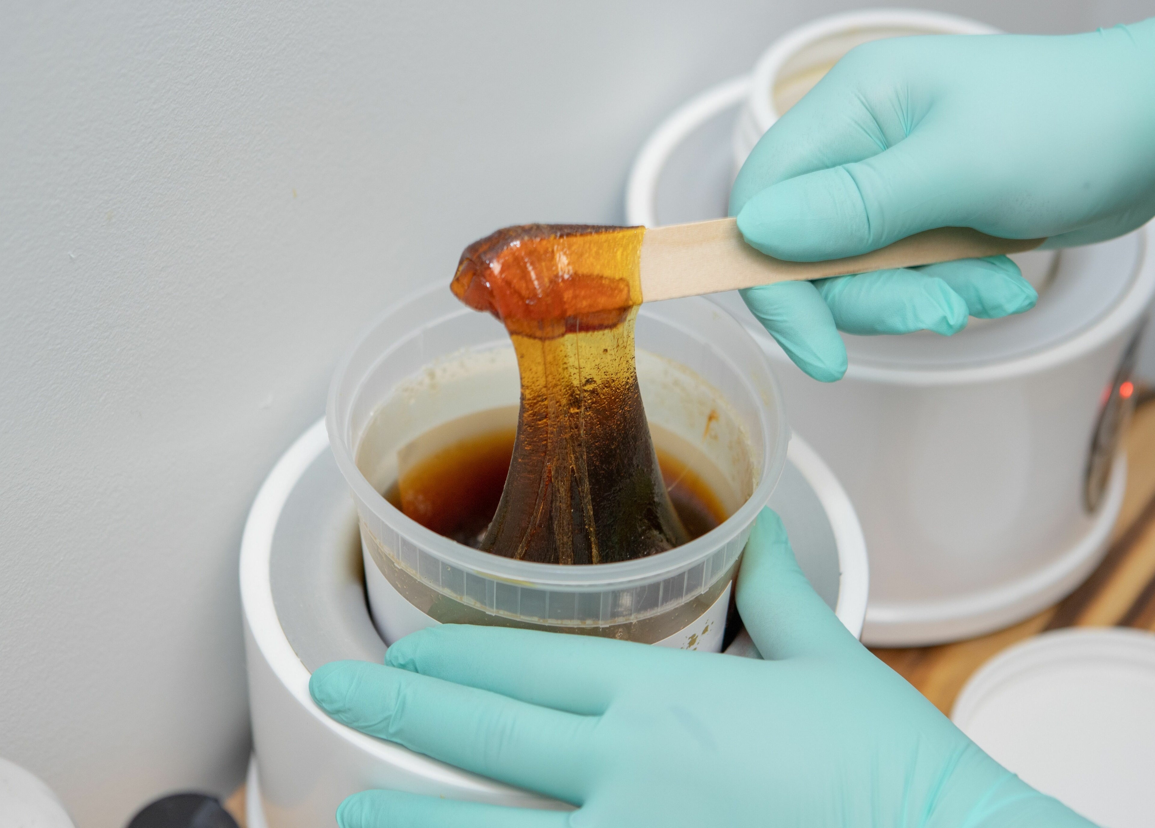 Sugaring treatment preparation by gloved hands at Lovely Sugaring, Toronto, Ontario, CA.