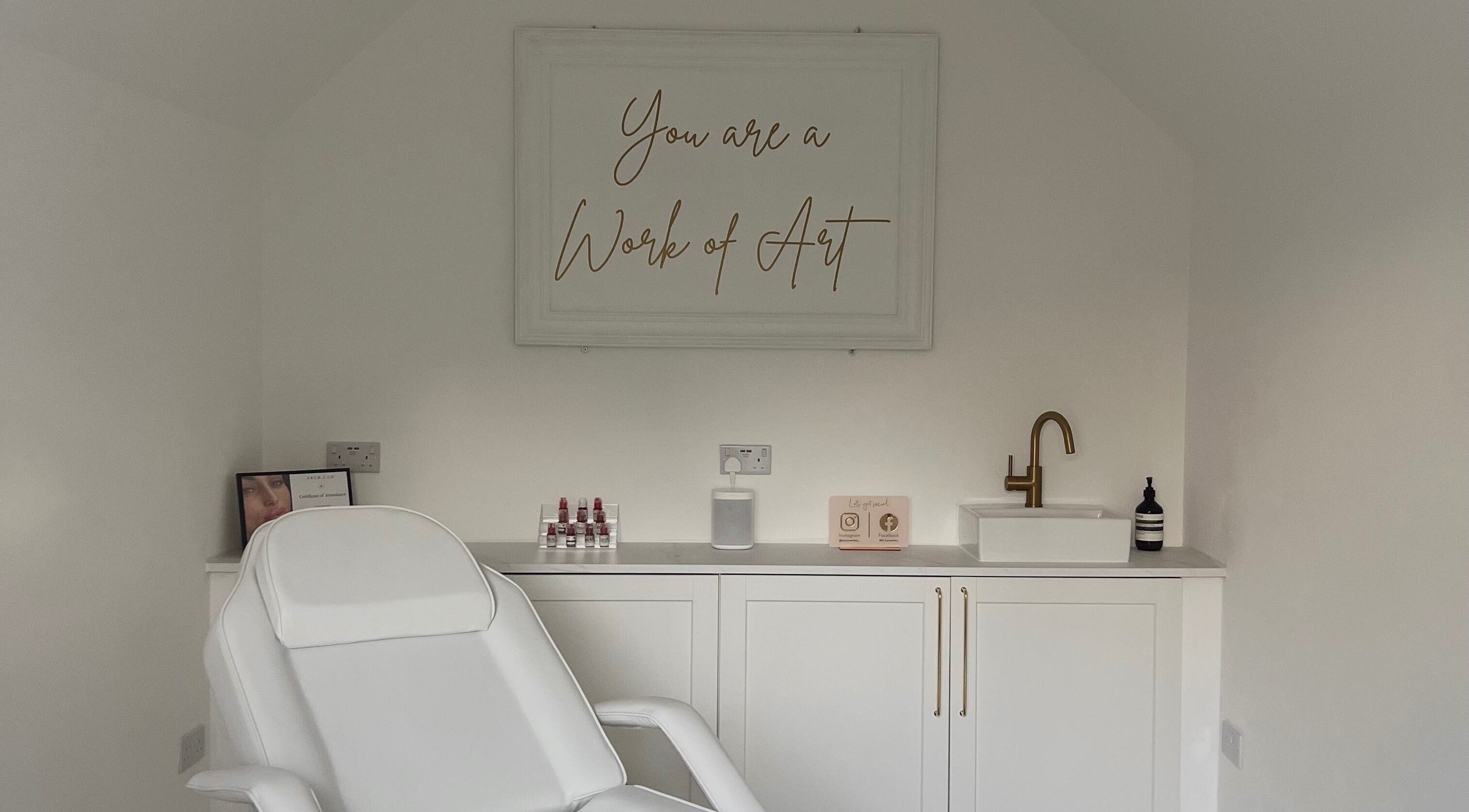 Elevate Cosmetics in Chippenham, England, GB features a serene treatment room with elegant decor and a modern chair.