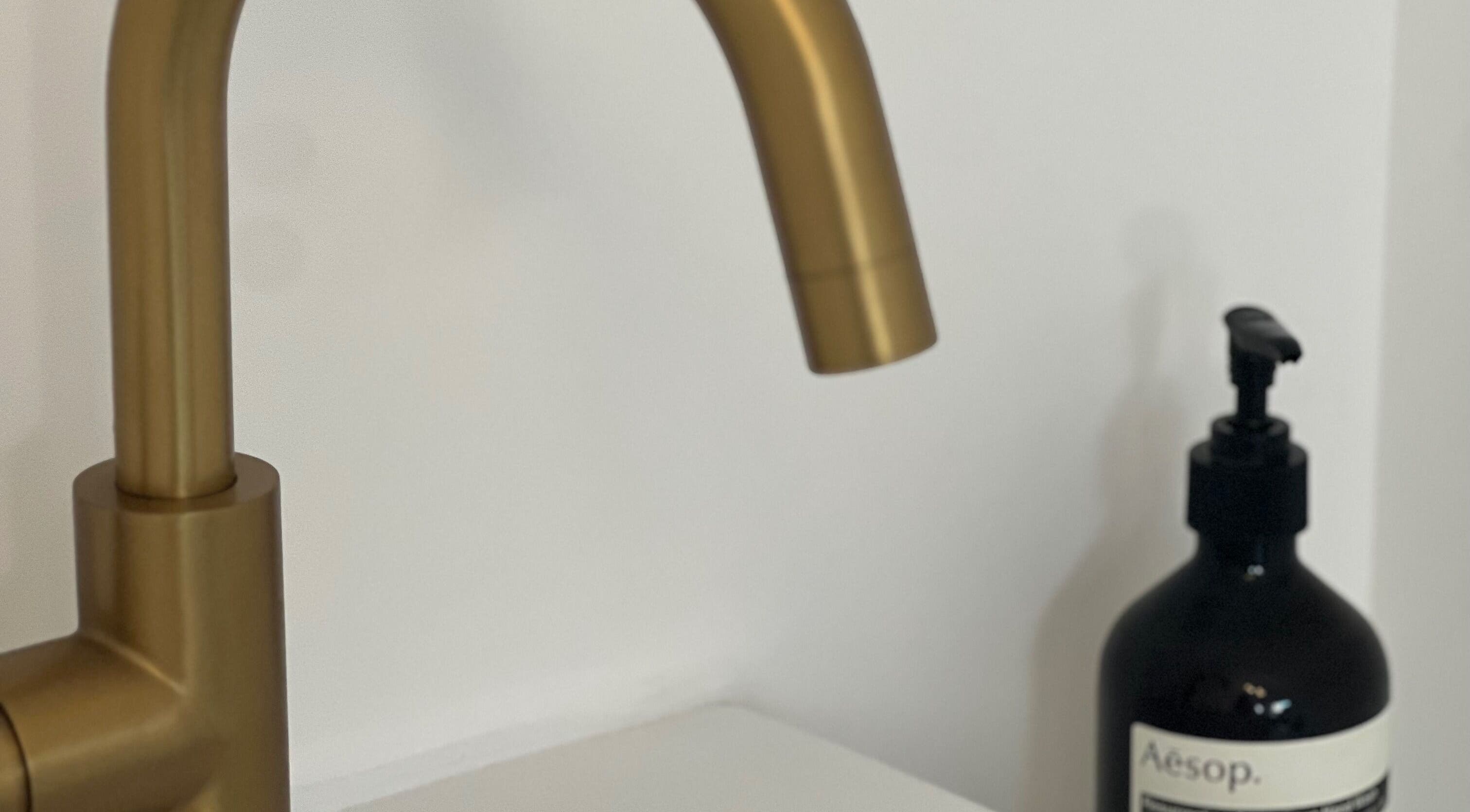 Elegant golden faucet and luxury soap at Elevate Cosmetics, Chippenham, England, GB.