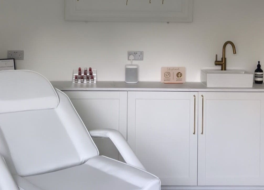 Bright treatment room at Elevate Cosmetics, Chippenham, England, with a comfy chair and modern decor.