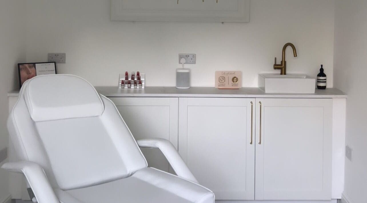Bright treatment room at Elevate Cosmetics, Chippenham, England, with a comfy chair and modern decor.