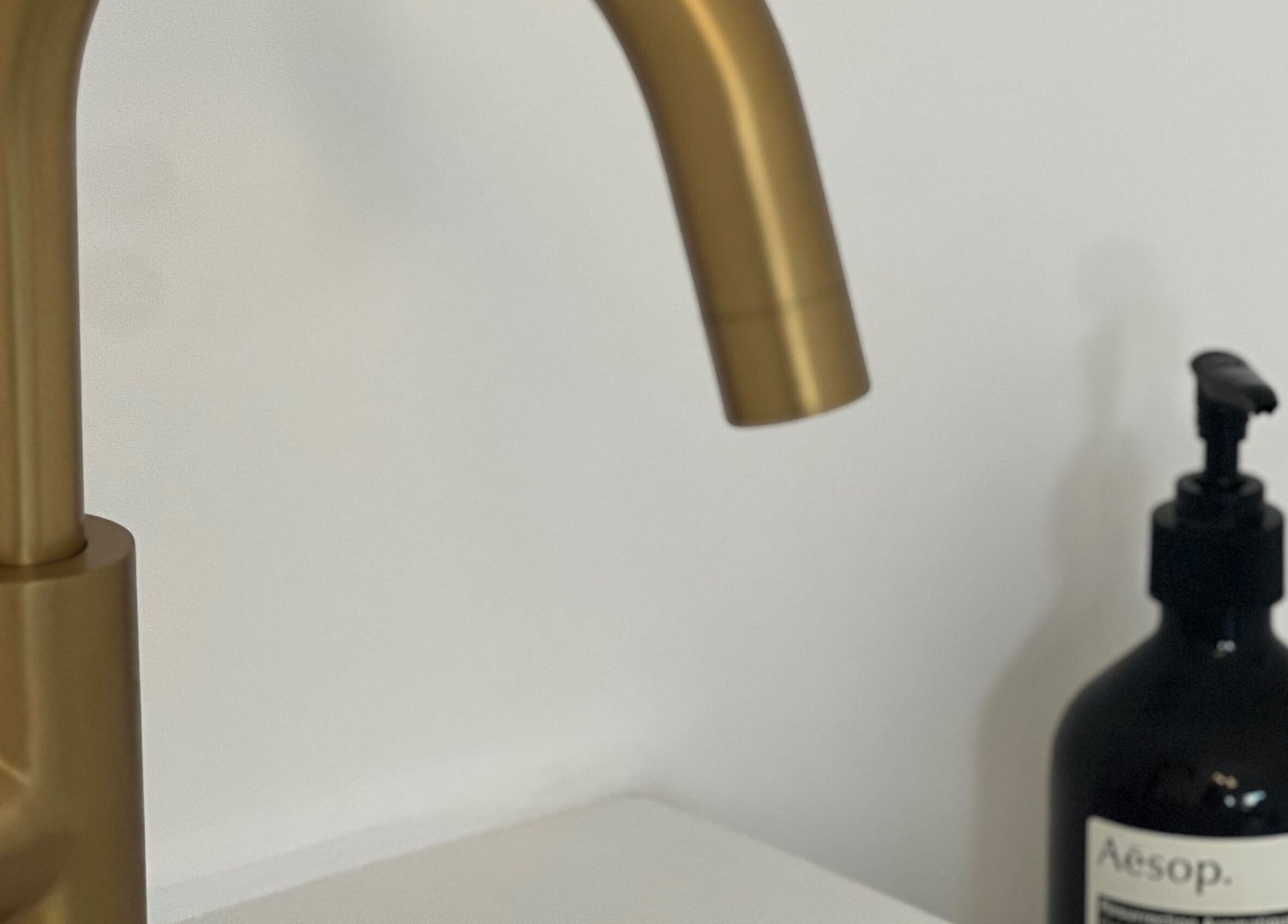 Sleek gold faucet at Elevate Cosmetics, Chippenham, England, GB - modern elegance in beauty and wellness.