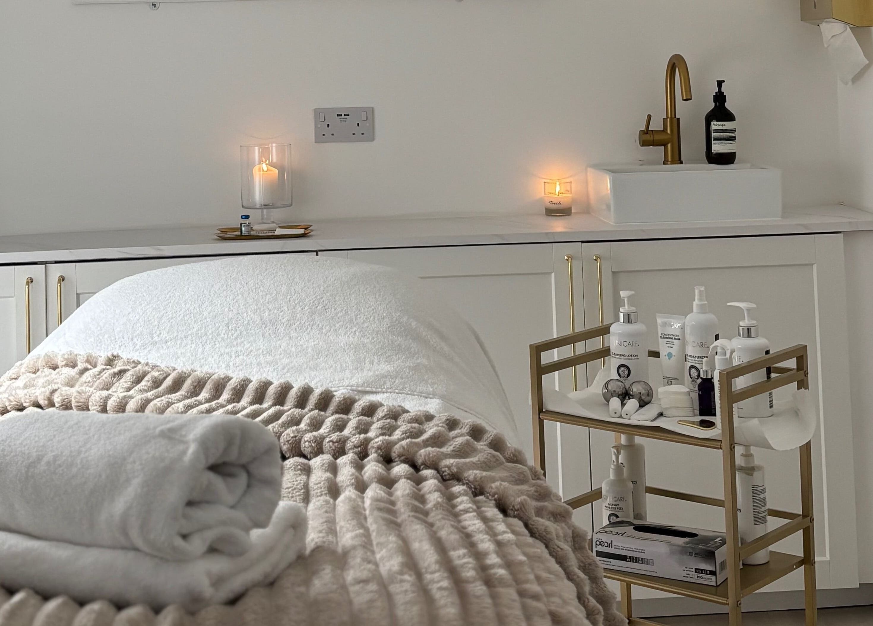 Cozy, elegant spa room at Elevate Cosmetics, Chippenham, England, GB with soft towels and warm lighting.