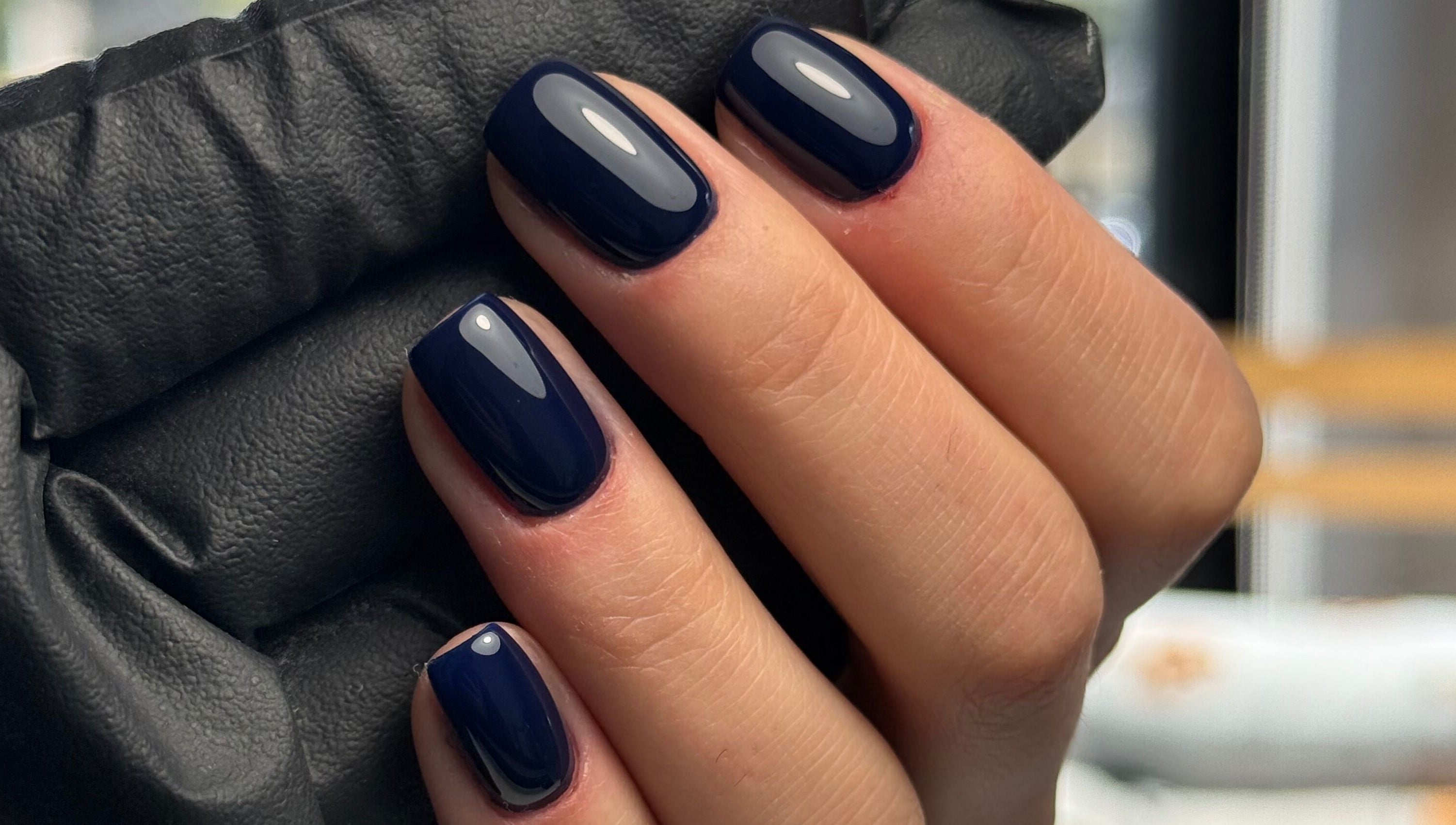 Stylish dark blue manicured nails at La Petite Onglerie & Co., Mascouche, Québec, CA.