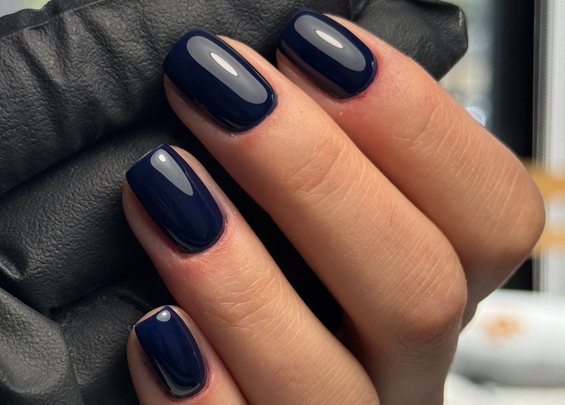Stylish dark blue manicured nails at La Petite Onglerie & Co., Mascouche, Québec, CA.