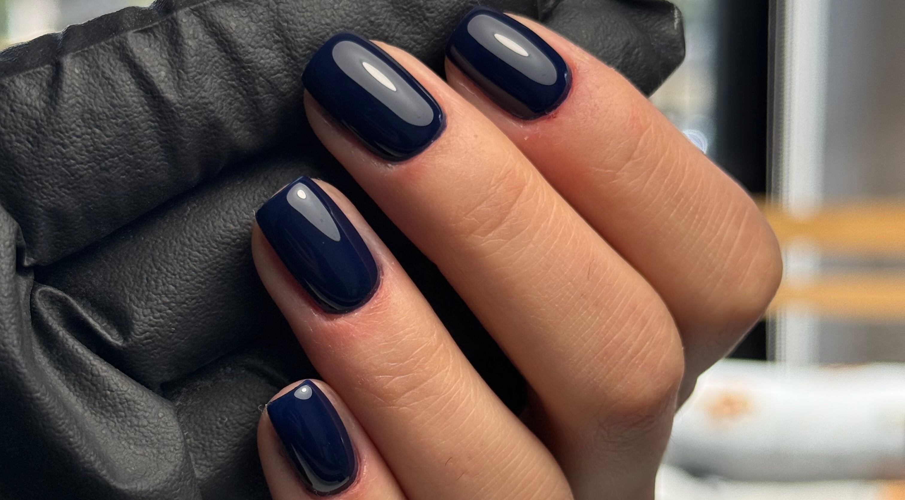 Stylish dark blue manicured nails at La Petite Onglerie & Co., Mascouche, Québec, CA.