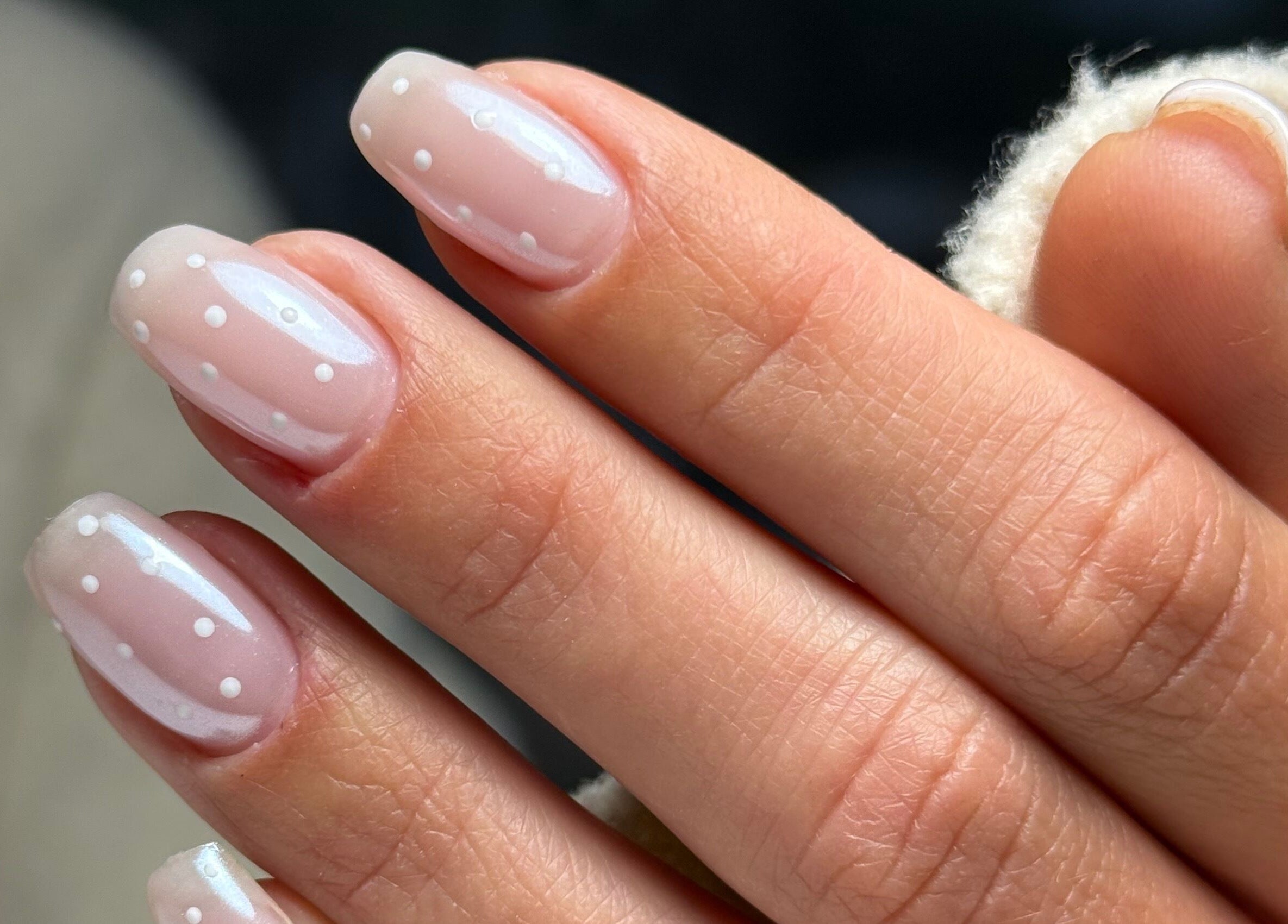 Polka dot nail art at La Petite Onglerie & Co., Mascouche, Québec, CA offers a chic, modern look.