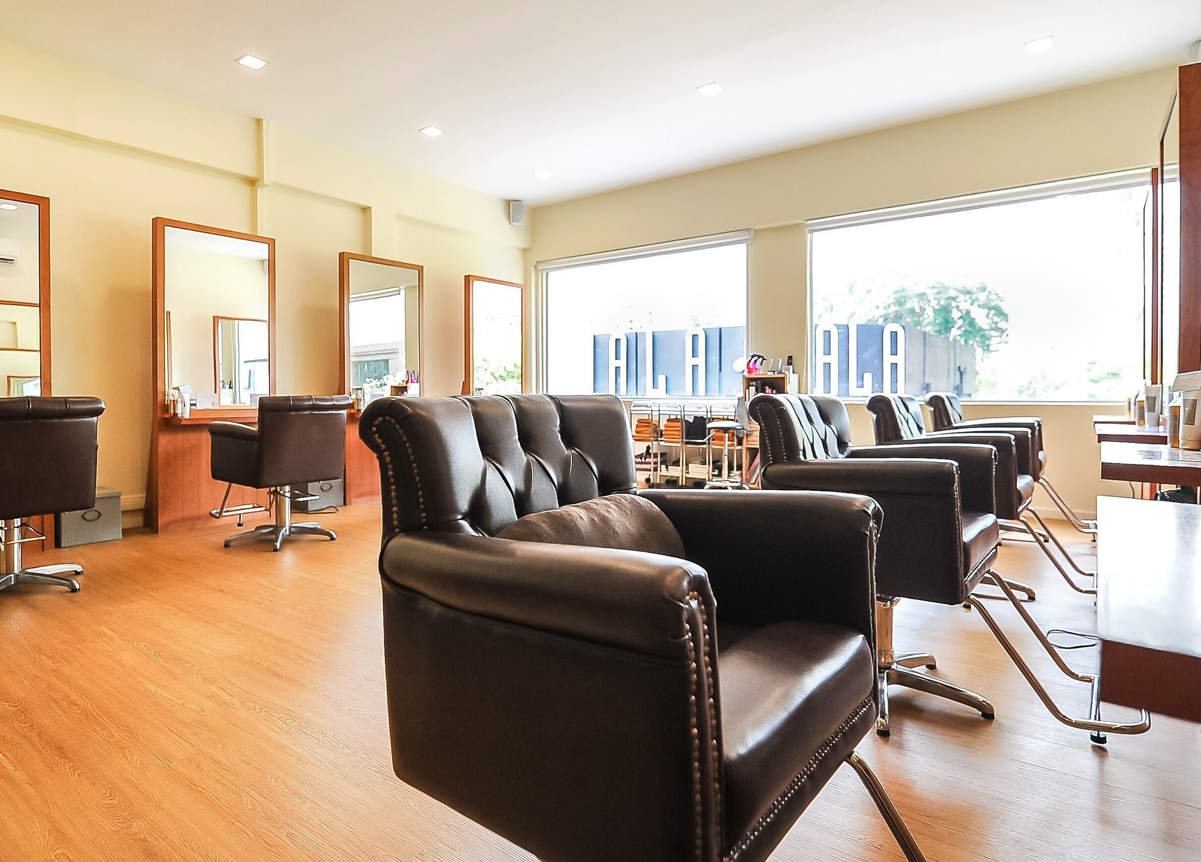 Stylish interior of Art-Noise Japanese Beauty Hair Salon SG, Singapore with modern chairs and mirrors.
