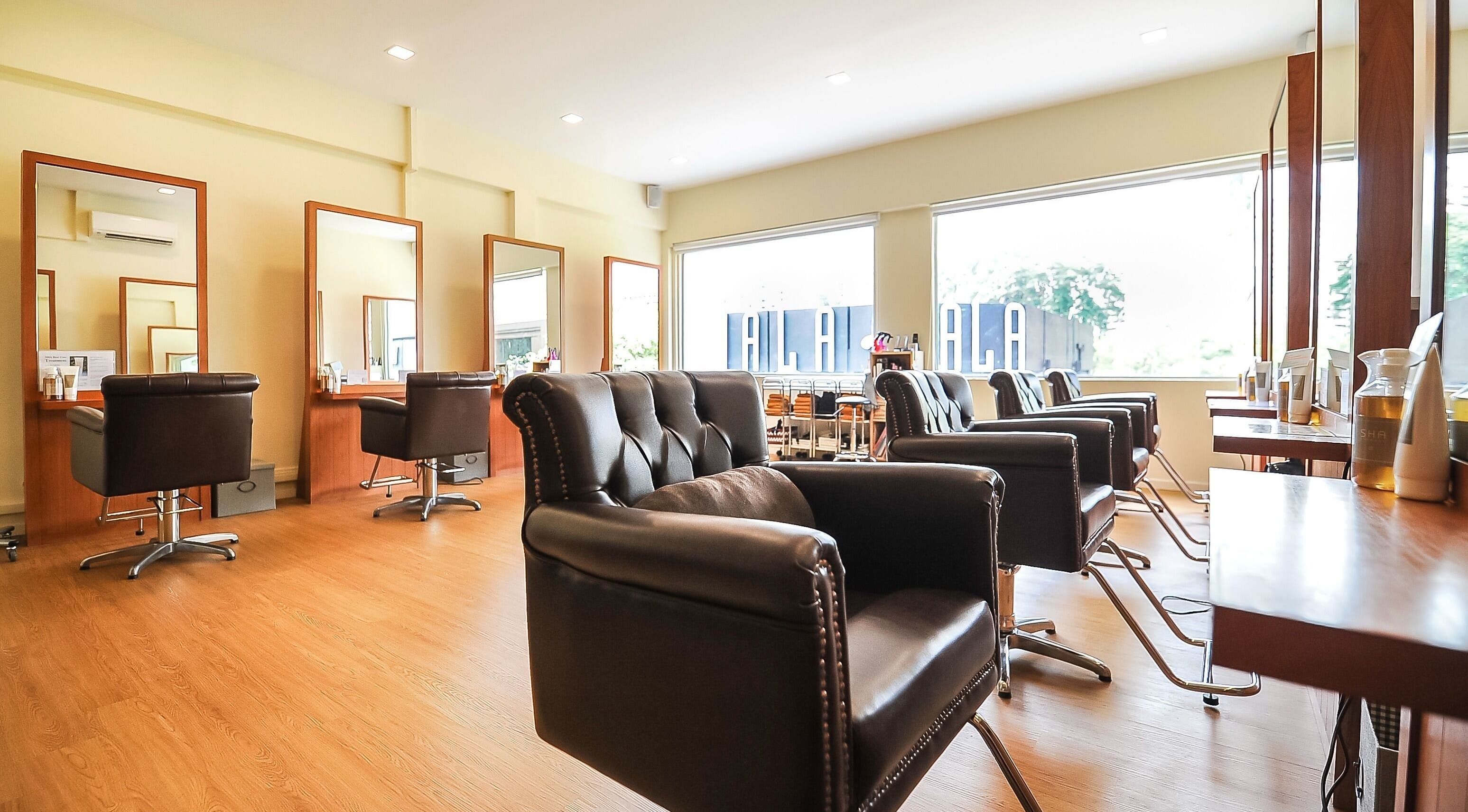 Stylish interior of Art-Noise Japanese Beauty Hair Salon SG, Singapore with modern chairs and mirrors.