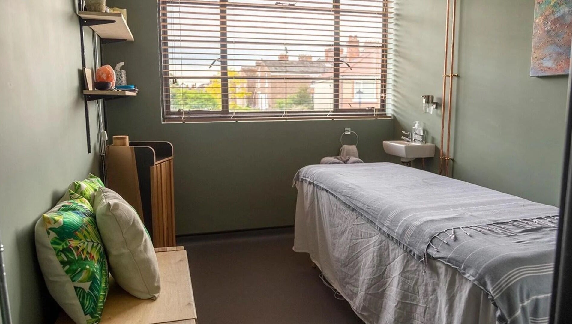 Calming spa room at The Healing Spa, Portsmouth, England, GB with a massage table and tranquil decor.