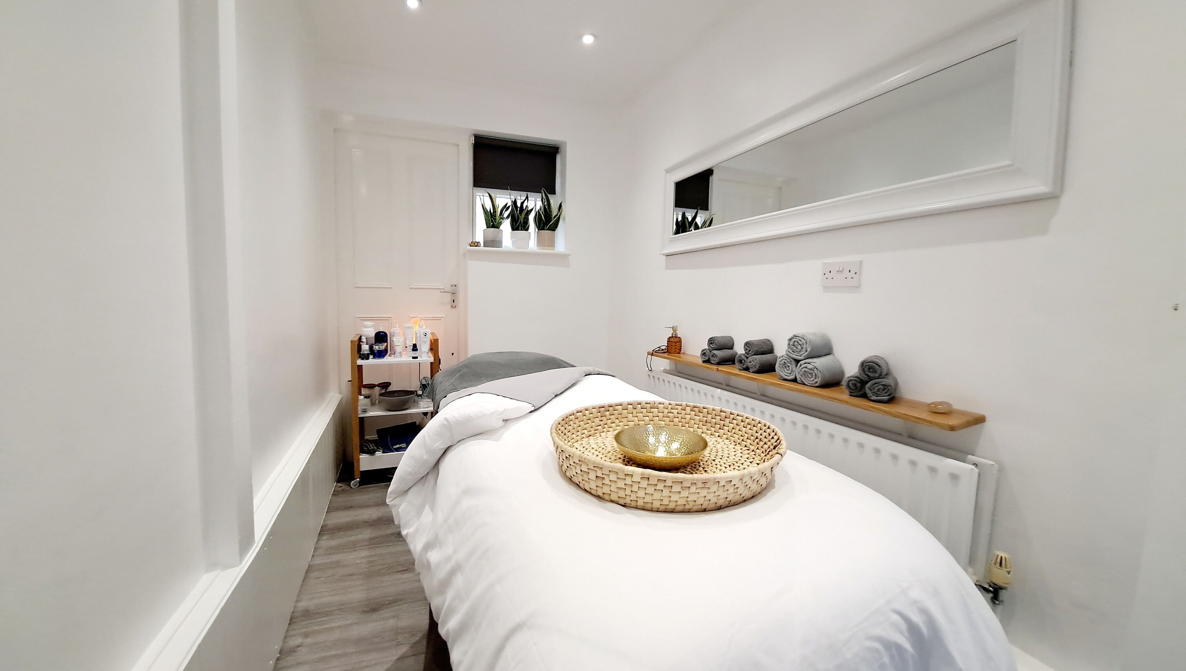 Calming treatment room at My Face Spa, London, England, GB with a cozy massage bed and soft lighting.