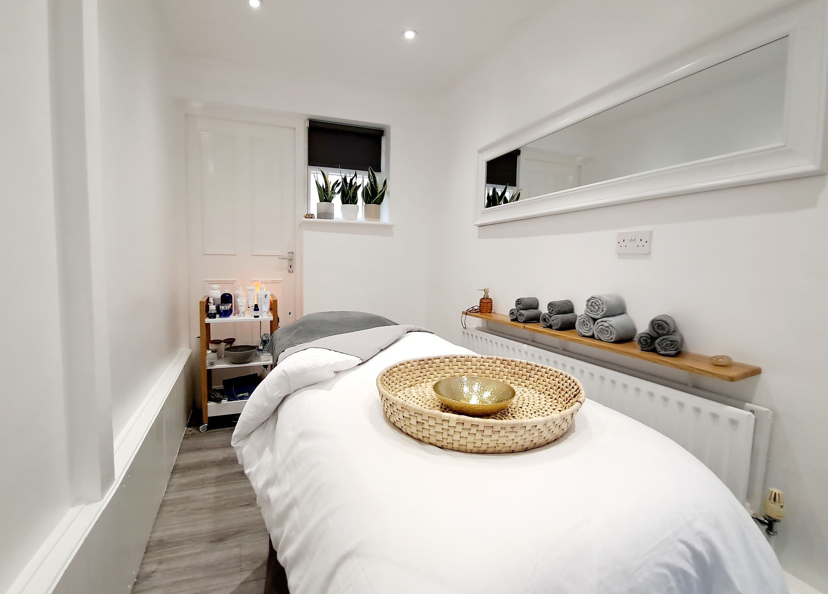 Calming treatment room at My Face Spa, London, England, GB with a cozy massage bed and soft lighting.