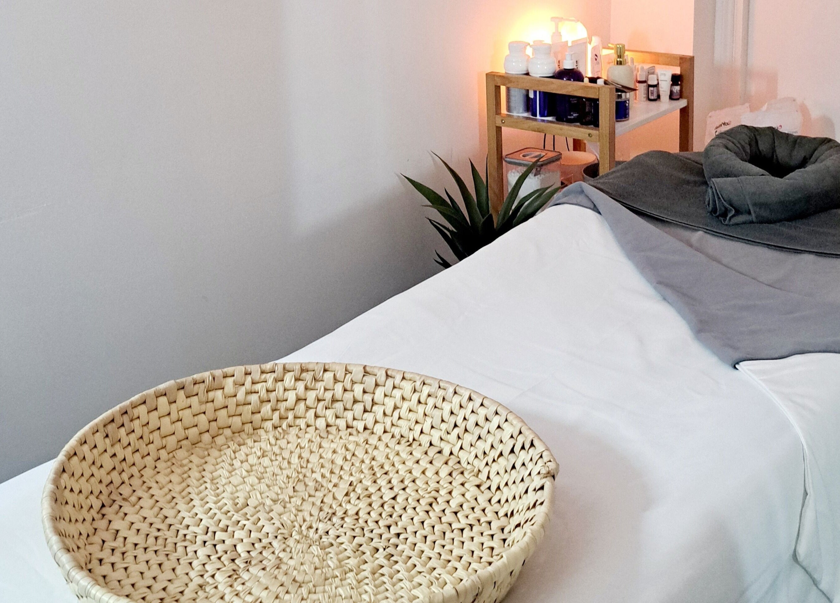 Relaxing treatment room at My Face Spa, London, England, GB, featuring a tidy bed and ambient lighting.