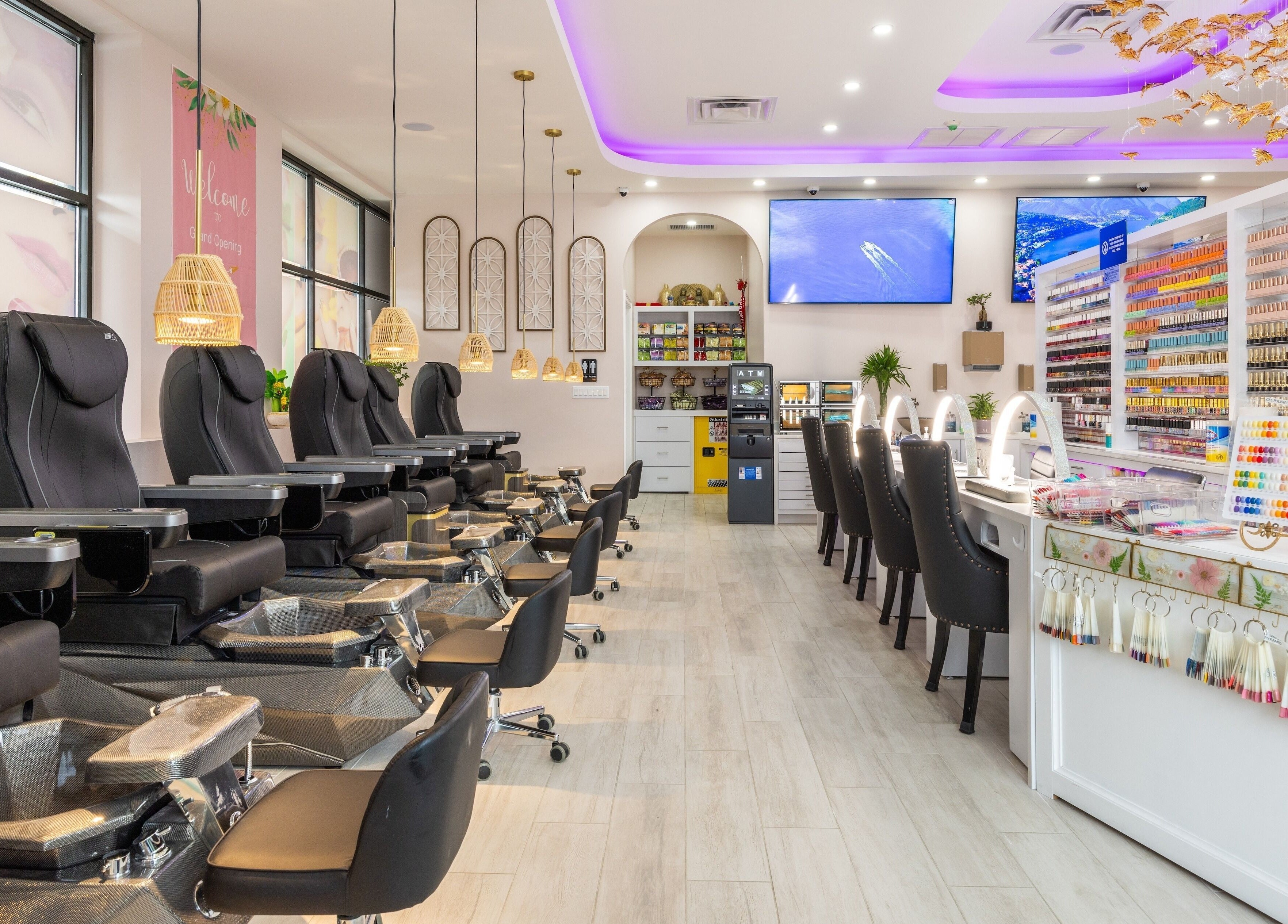 Elegant salon interior of The Nail Palace in Lowell, Massachusetts, US with plush seating and vibrant nail polishes.
