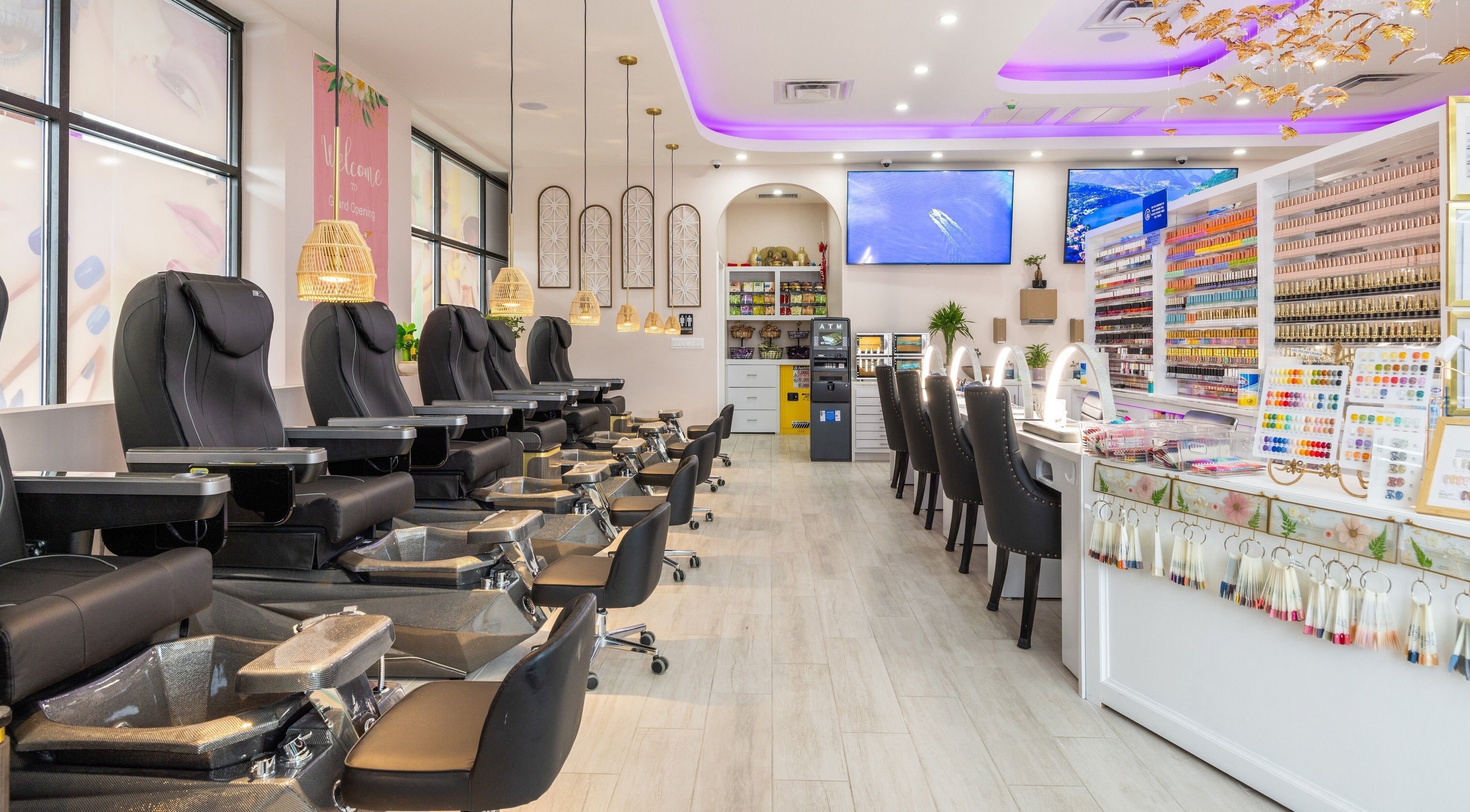 Elegant salon interior of The Nail Palace in Lowell, Massachusetts, US with plush seating and vibrant nail polishes.