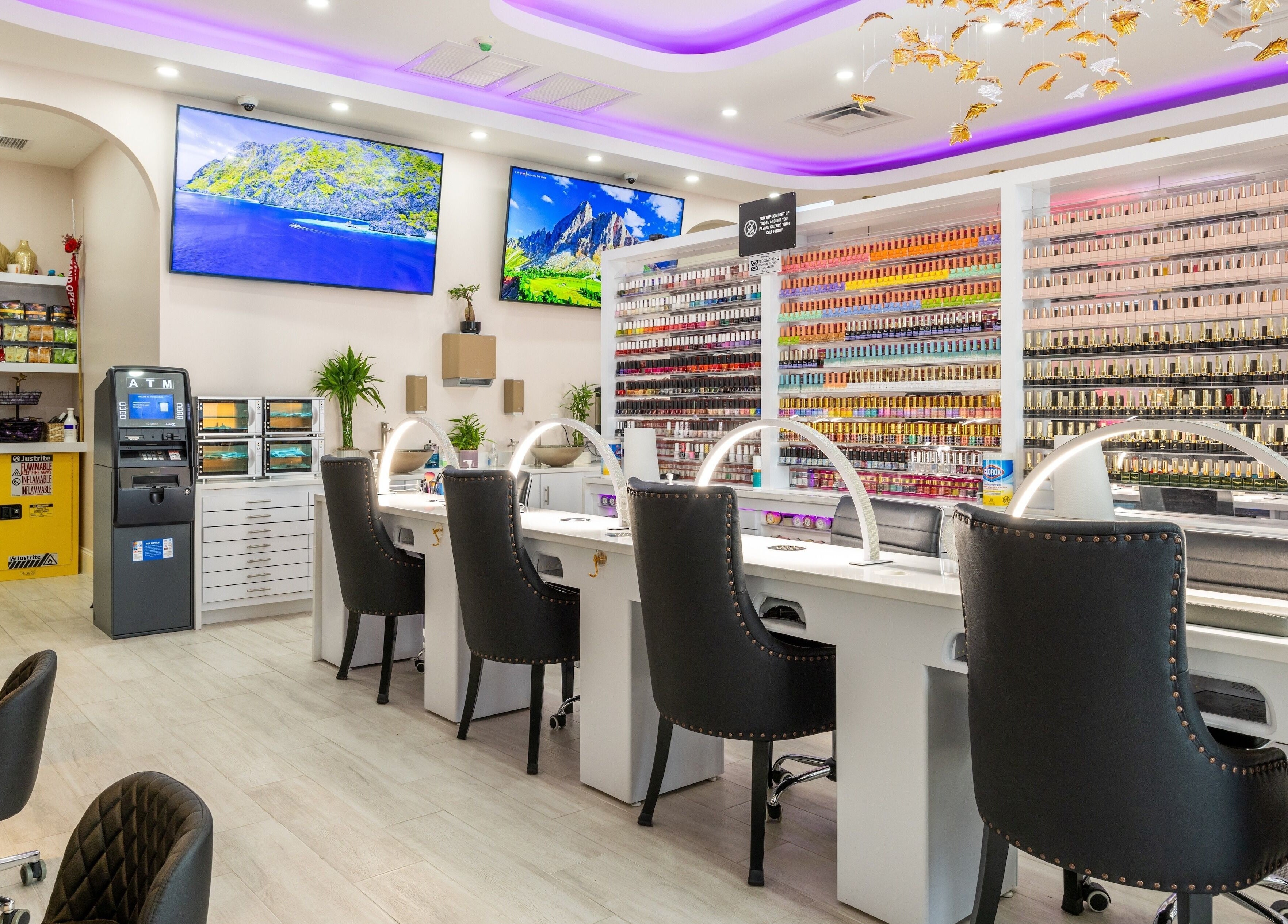 Interior of The Nail Palace in Lowell, Massachusetts, US, featuring elegant nail stations and vibrant polish display.