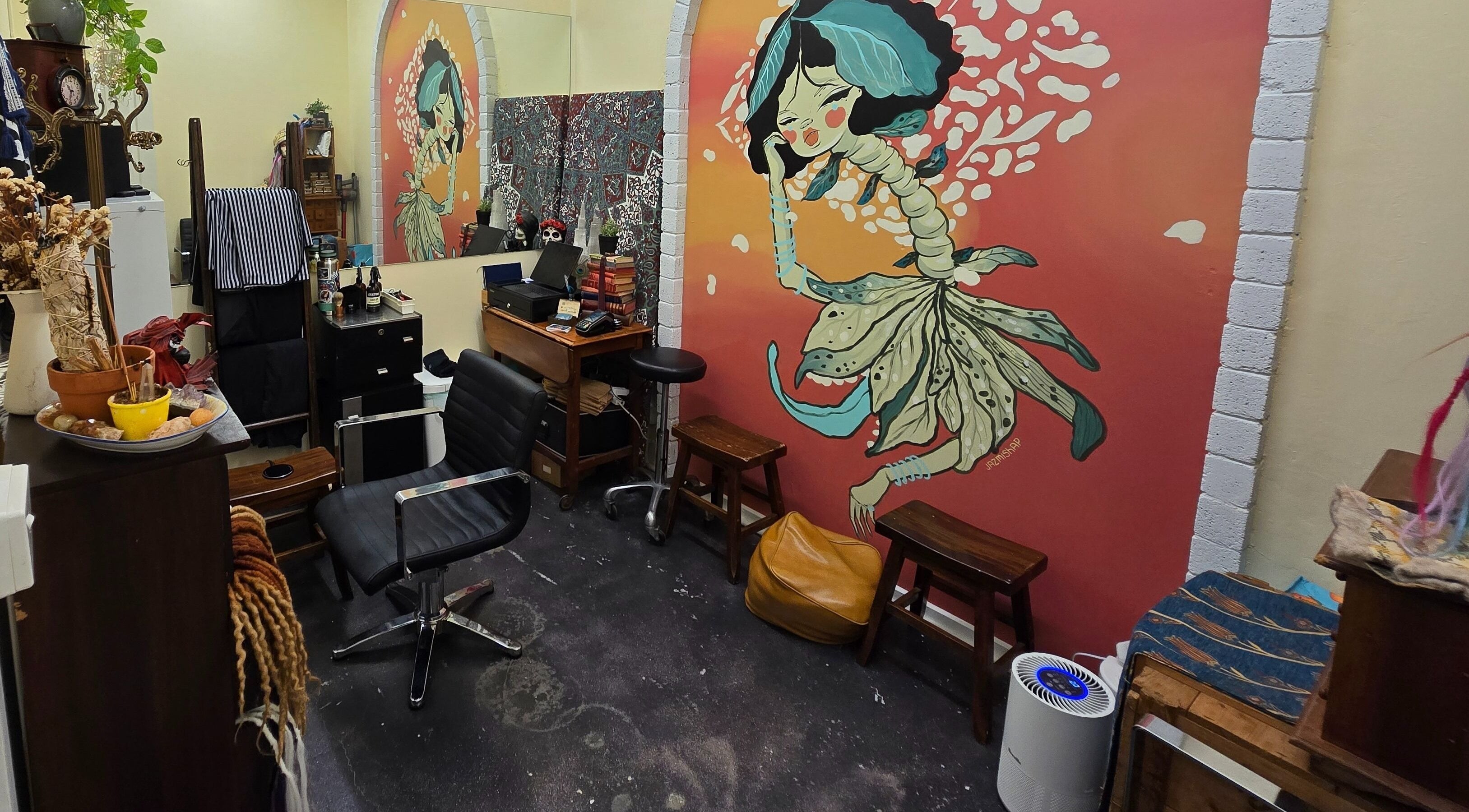 Vibrant mural adorns Lokk Mechanic in Melbourne, Victoria, AU. Artistic decor enhances a cozy beauty space.