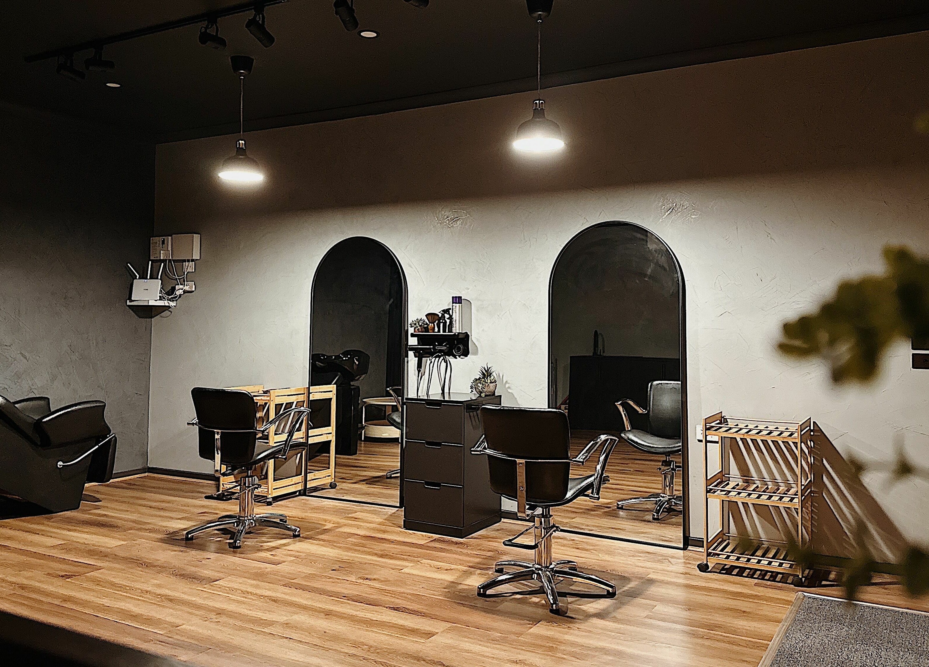 Stylish interior of Elly’s Studio in Melbourne, Victoria, AU showcasing modern salon chairs and mirrors.
