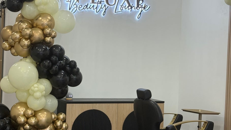 Sophisticated interior at N’Luxe Beauty Lounge, Chicago, Illinois, US with chic balloon decor and cozy seating.