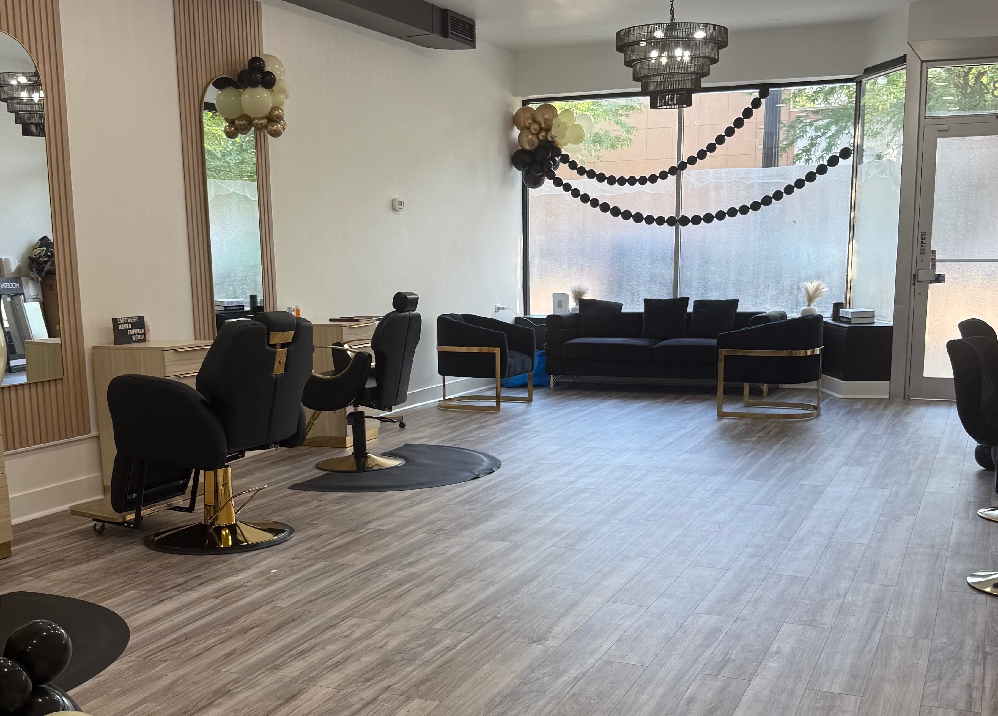 Elegant interior of N’Luxe Beauty Lounge in Chicago, Illinois, US with stylish chairs and decor.