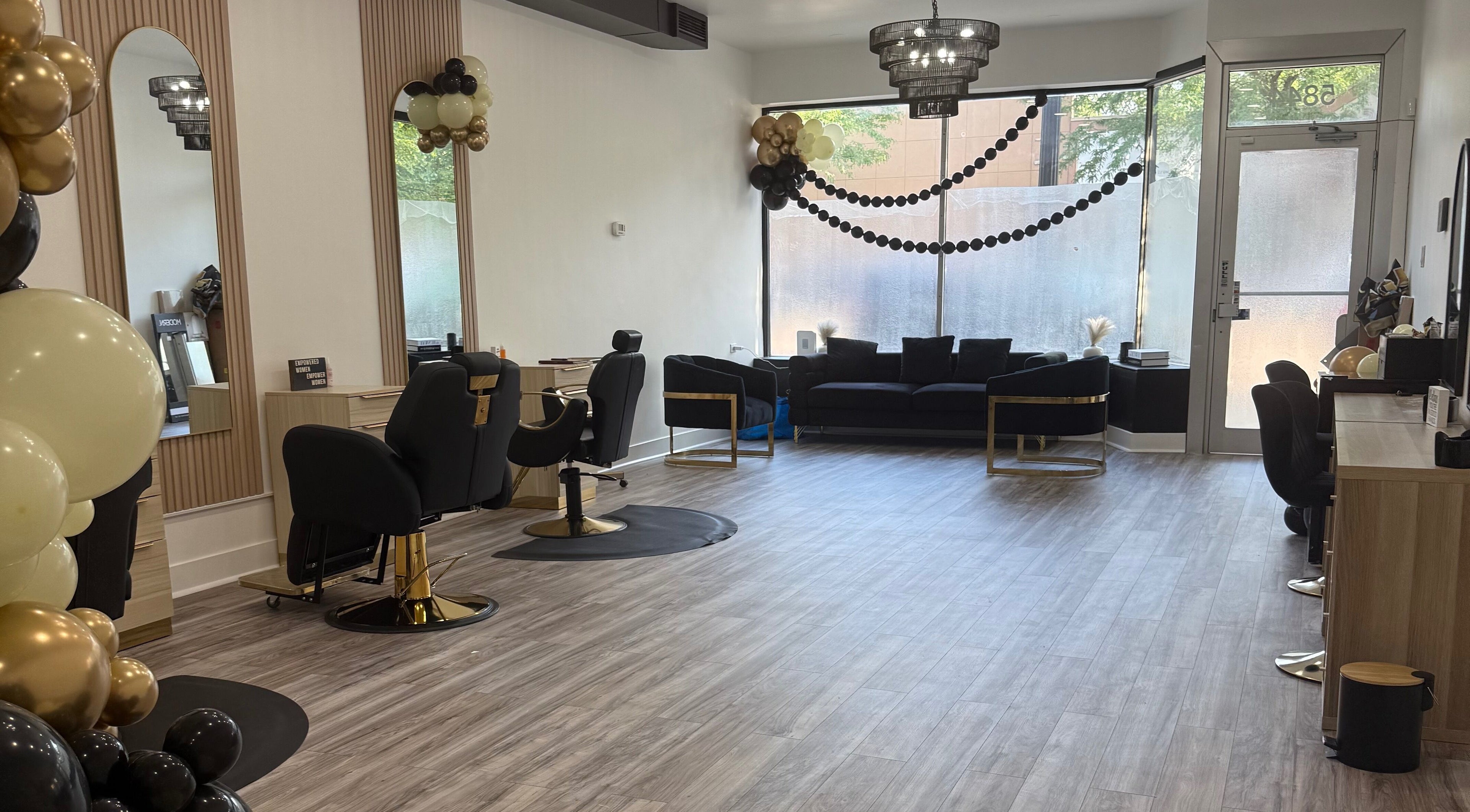 Elegant interior of N’Luxe Beauty Lounge in Chicago, Illinois, US with stylish chairs and decor.