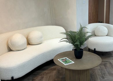 Elegant seating at Jennifer Holmes Hair and Beauty Ltd, Masham, England, GB, featuring a modern cream sofa.