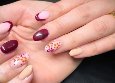 Stylish nail art at House of Wax, Wrexham, Wales, GB featuring floral designs and rich colors.