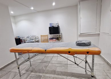 Calming treatment room at La Baba, London, England, GB featuring a massage table and peaceful ambiance.