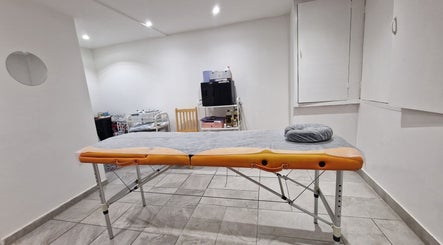 Calming treatment room at La Baba, London, England, GB featuring a massage table and peaceful ambiance.
