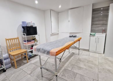 Bright treatment room at La Baba, London, England, GB featuring cozy table and modern decor.