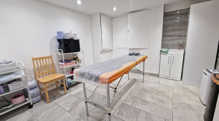 Bright treatment room at La Baba, London, England, GB featuring cozy table and modern decor.