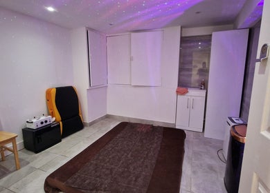 Peaceful spa room at La Baba, London, England, GB with massage table and soft lighting.