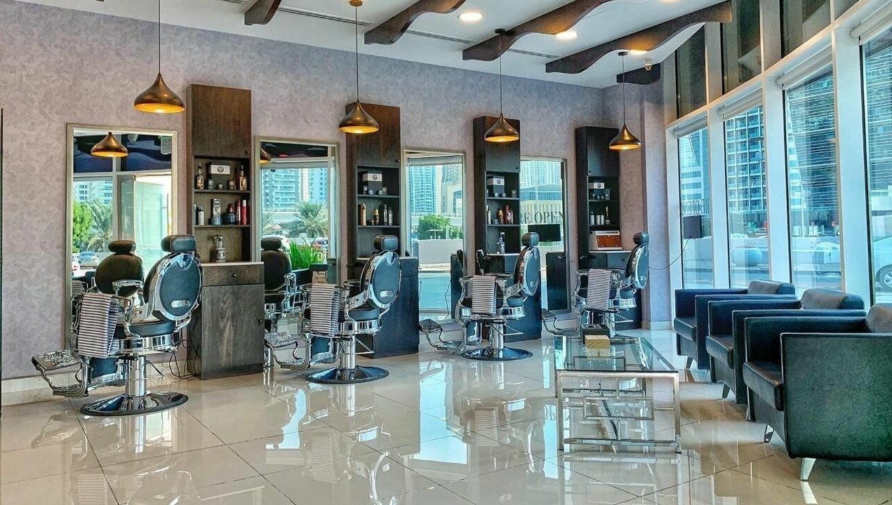 Luxurious interior of Black Tie Salon - Gent’s Spa and Barbershop in Dubai, Dubai, AE, featuring modern barber chairs.