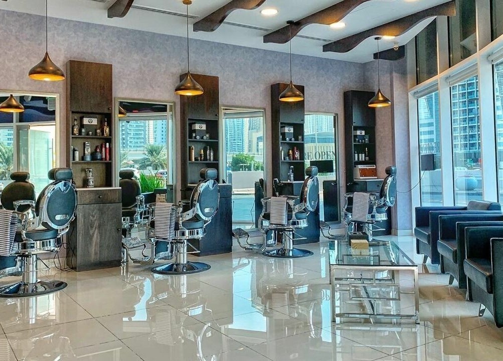 Luxurious interior of Black Tie Salon - Gent’s Spa and Barbershop in Dubai, Dubai, AE, featuring modern barber chairs.